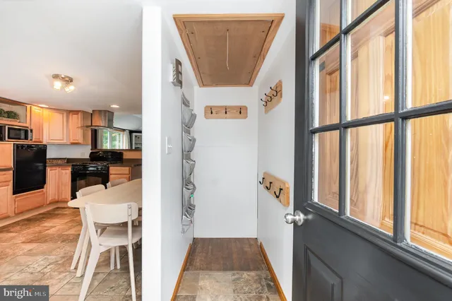 a kitchen with a refrigerator and a stove top oven
