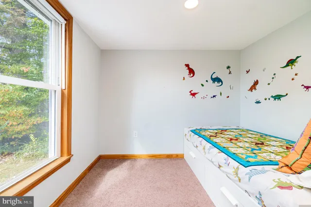 a view of entryway with furniture and wooden floor