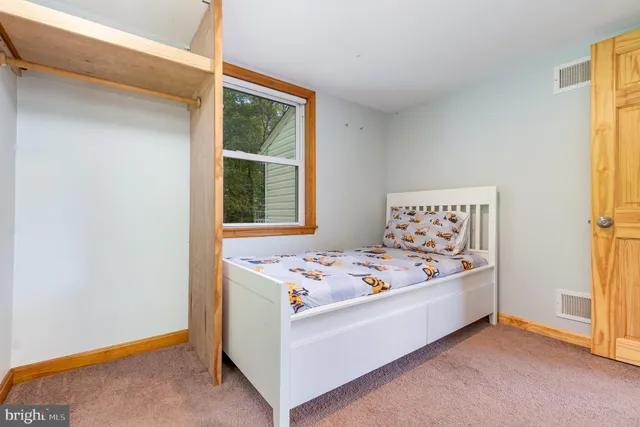 a bedroom with a bed and a dresser