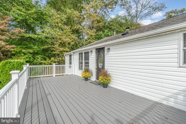 a view of backyard with a deck and wooden floor