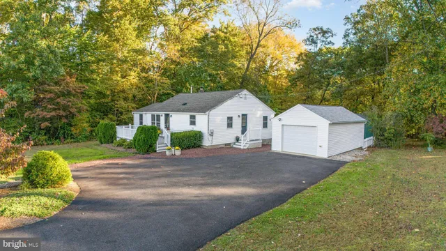 a front view of a house with yard and green space