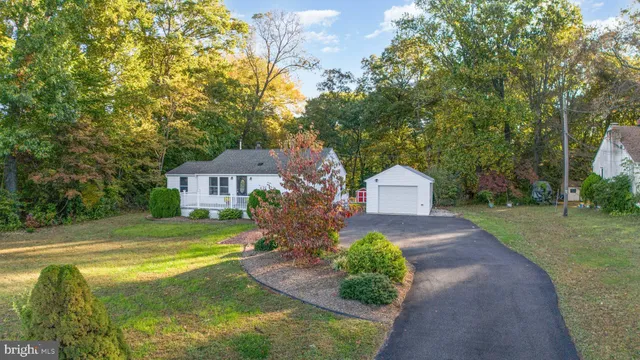 a front view of a house with a yard and trees