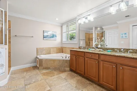 a bathroom with a tub a sink and a window