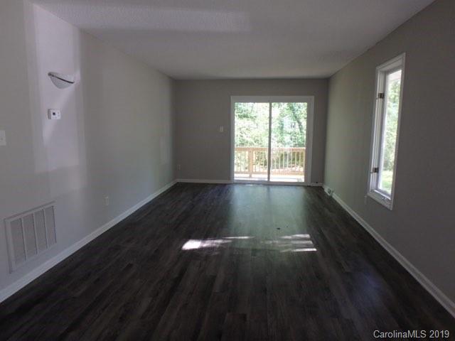 2343 Roland Drive, Unit D Monroe, NC 28110 - Photo 2 of 13 a view of an empty room with wooden floor and a window