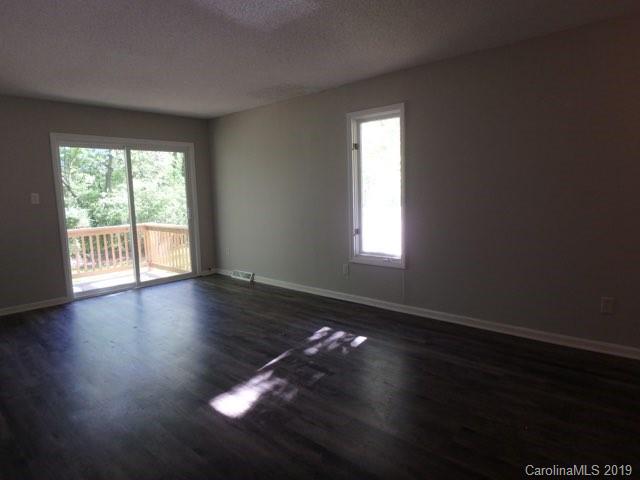 2343 Roland Drive, Unit D Monroe, NC 28110 - Photo 3 of 13 a view of an empty room with wooden floor and a window