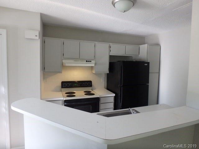2343 Roland Drive, Unit D Monroe, NC 28110 - Photo 4 of 13 a kitchen with a refrigerator and a stove