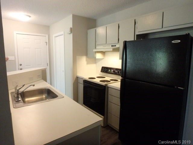 2343 Roland Drive, Unit D Monroe, NC 28110 - Photo 5 of 13 a kitchen with a refrigerator stove and sink