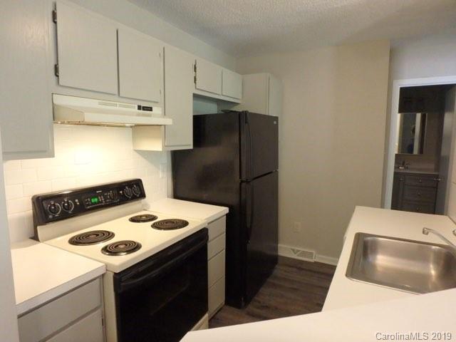 2343 Roland Drive, Unit D Monroe, NC 28110 - Photo 6 of 13 a kitchen with a stove and a refrigerator