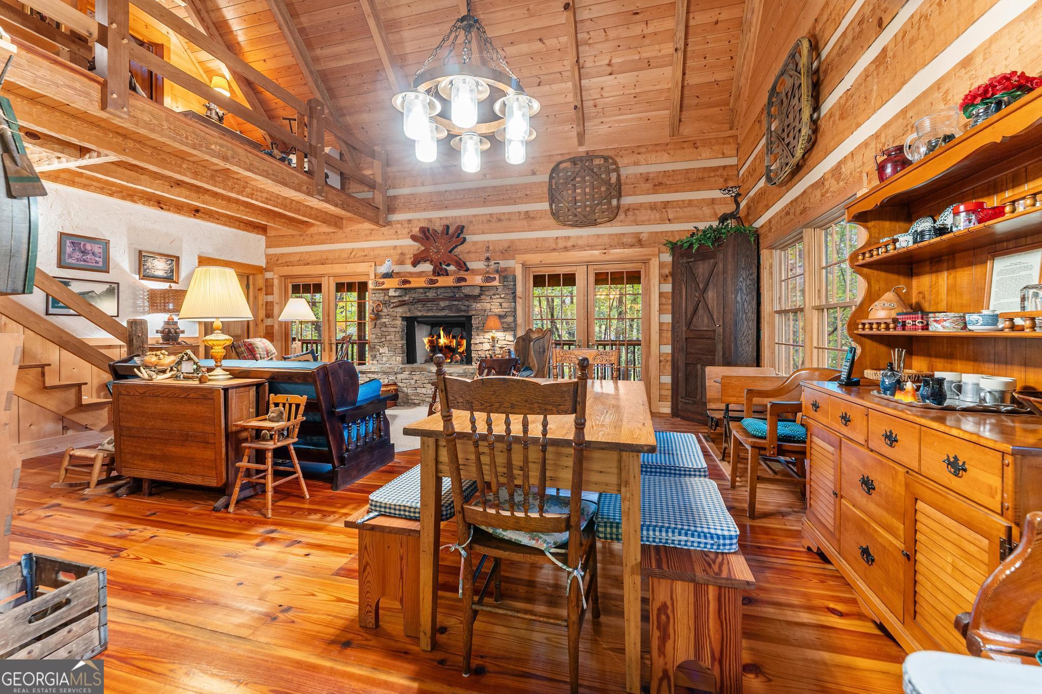 1127 Sautee Trail Sautee Nacoochee, GA 30571 - Photo 14 of 85 a view of a dining room with furniture a chandelier and kitchen view