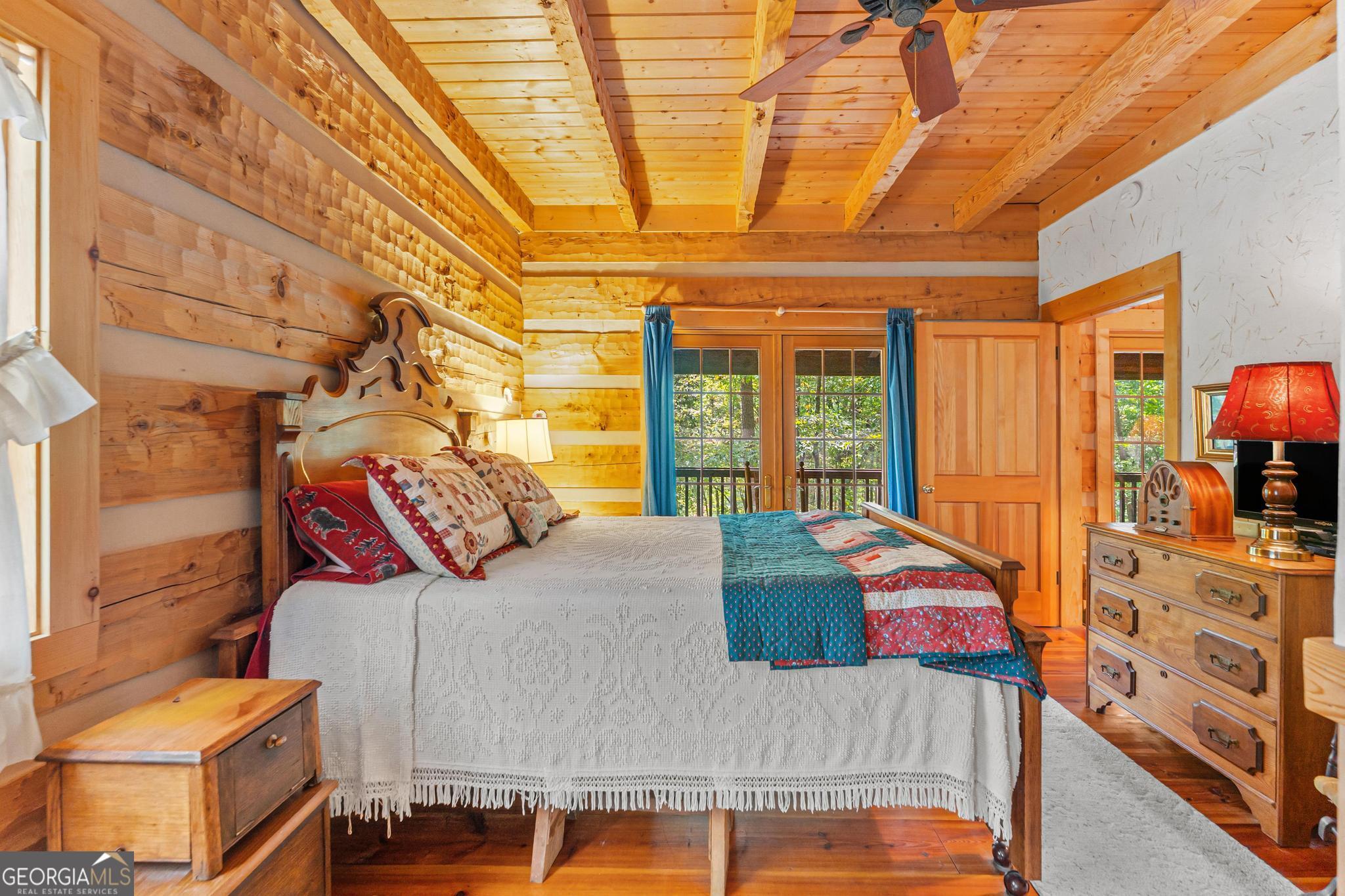 1127 Sautee Trail Sautee Nacoochee, GA 30571 - Photo 19 of 85 a bed sitting in a bedroom next to a window