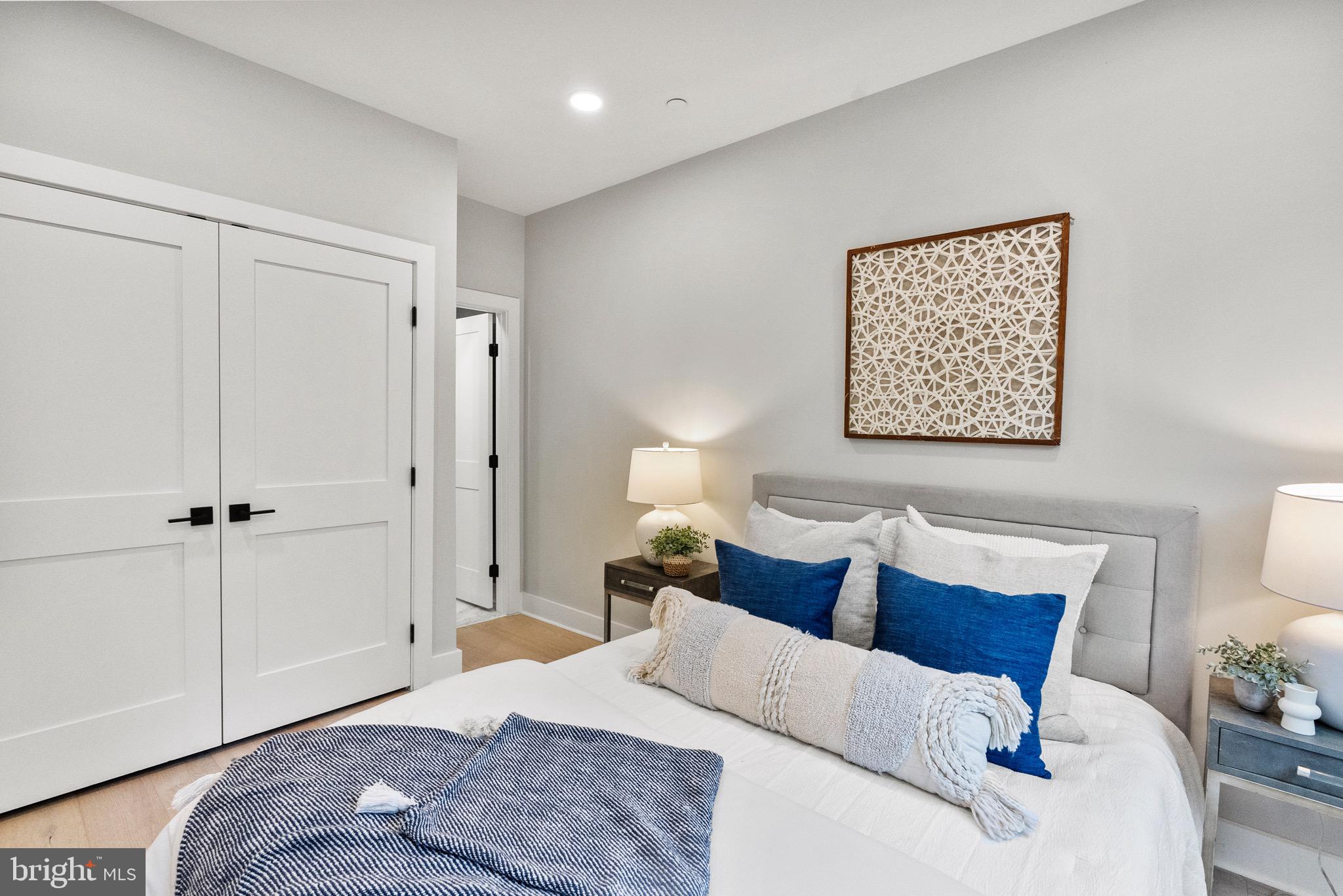 2019 M Street Northeast, Unit 1 Washington, DC 20002 - Photo 20 of 31 a bedroom with a bed and a painting on the wall