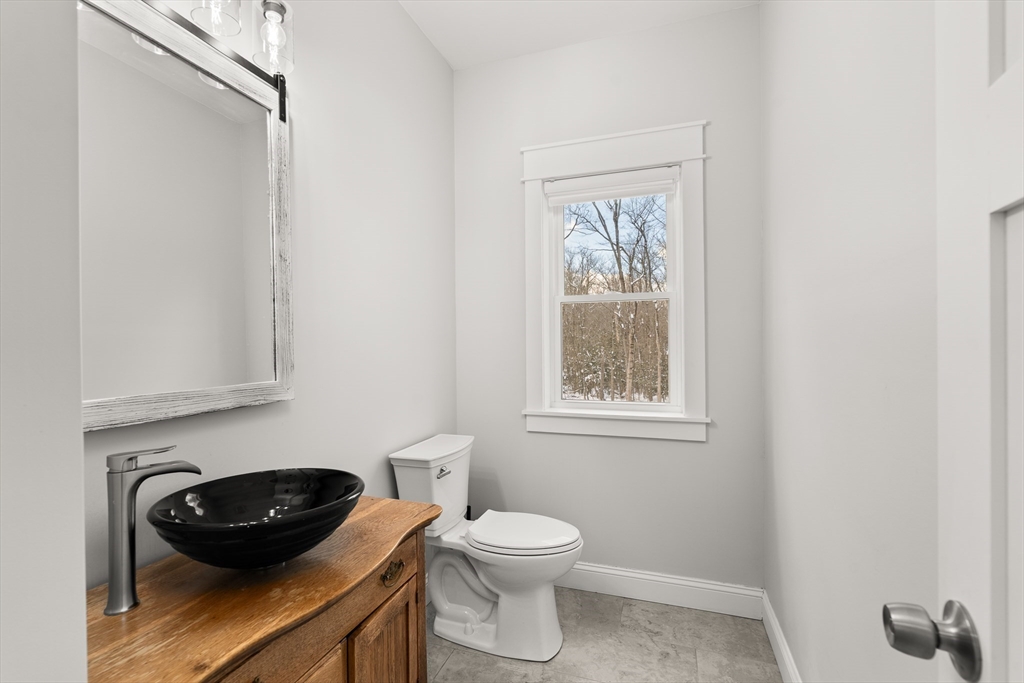 654 Skyline Trail Chester, MA 01011 - Photo 14 of 32 a bathroom with a toilet a sink and a window