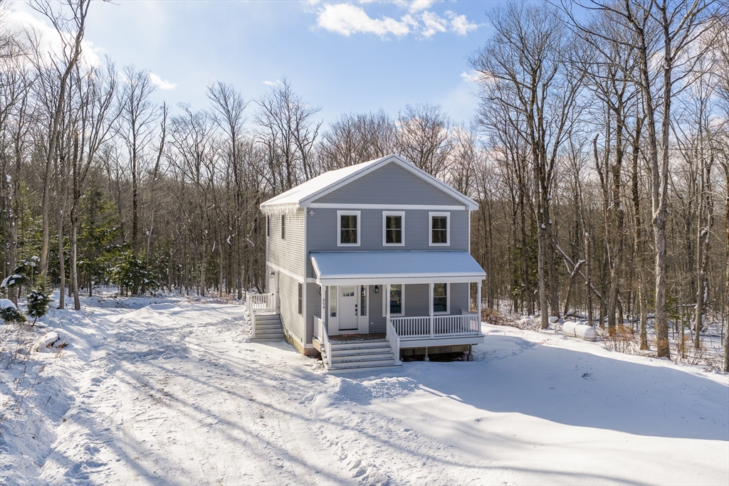 654 Skyline Trail Chester, MA 01011 - Photo 2 of 32 a front view of a house with a yard and garage