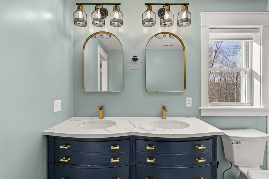 654 Skyline Trail Chester, MA 01011 - Photo 21 of 32 a utility room with two washing machine and two mirrors