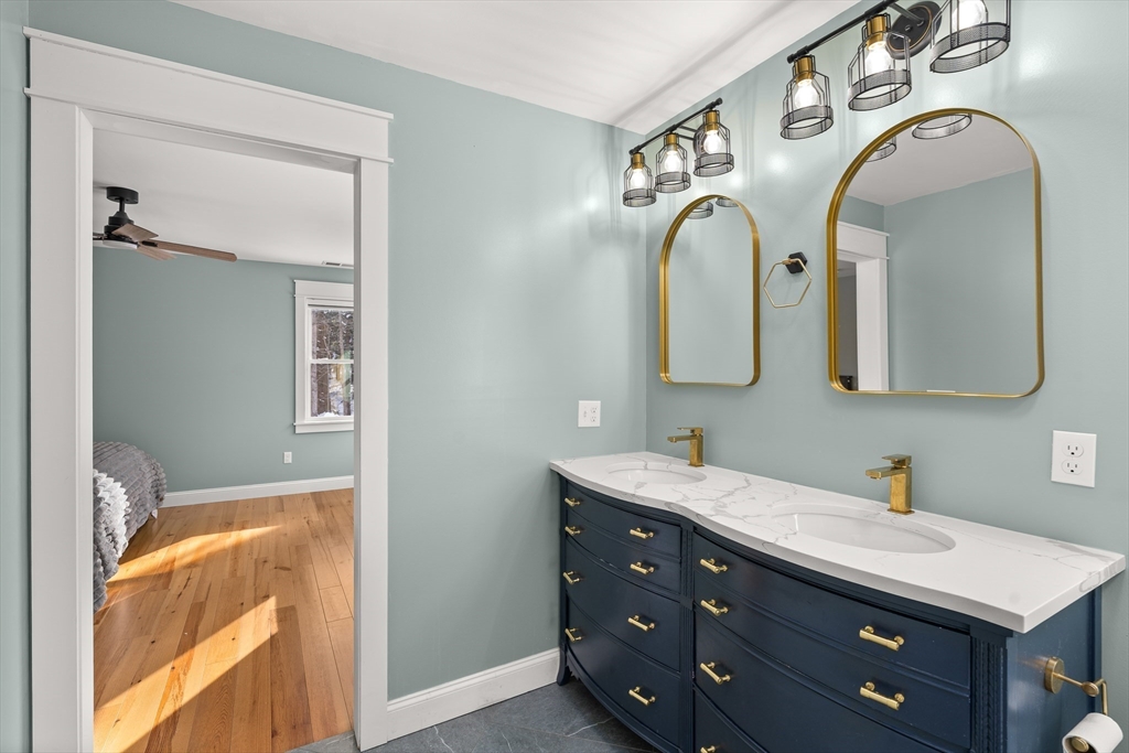 654 Skyline Trail Chester, MA 01011 - Photo 22 of 32 a bathroom with a granite countertop double vanity sink and a mirror