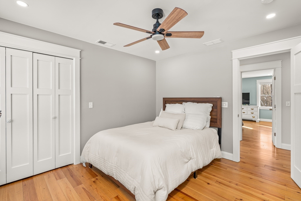 654 Skyline Trail Chester, MA 01011 - Photo 24 of 32 a bedroom with a bed and wooden floor