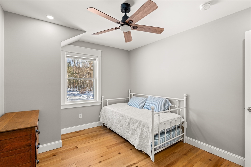 654 Skyline Trail Chester, MA 01011 - Photo 28 of 32 a bedroom with a bed and a ceiling fan
