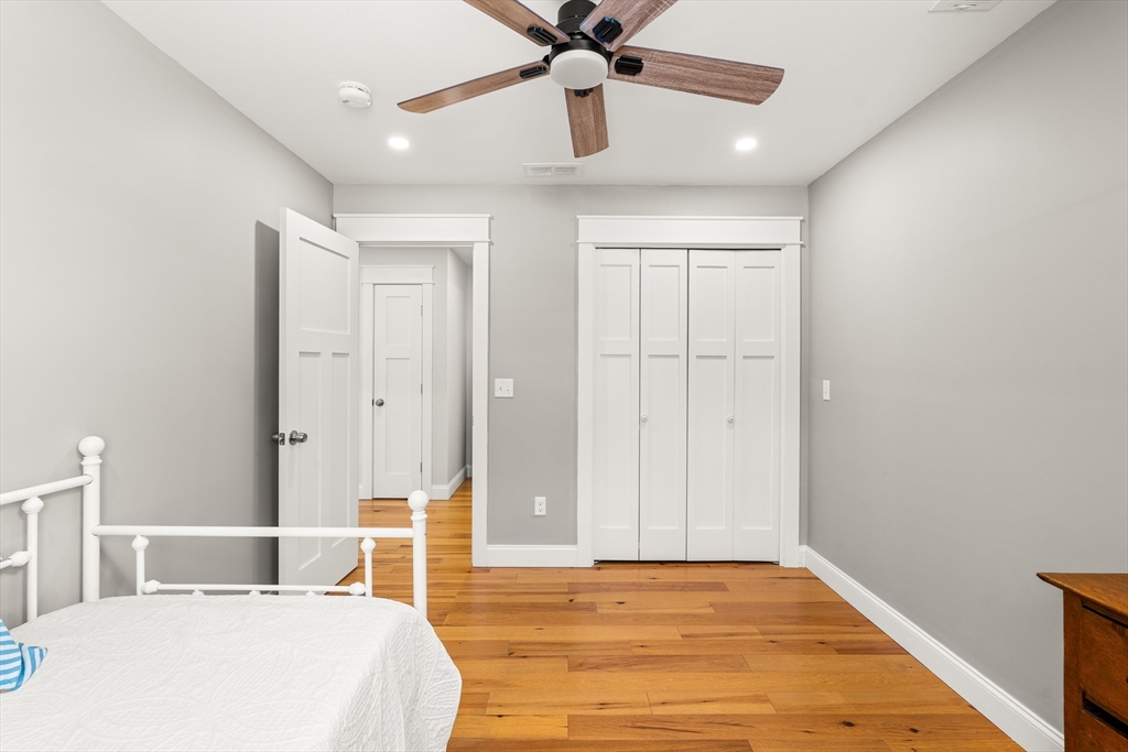 654 Skyline Trail Chester, MA 01011 - Photo 29 of 32 a bedroom with a bed and a chandelier