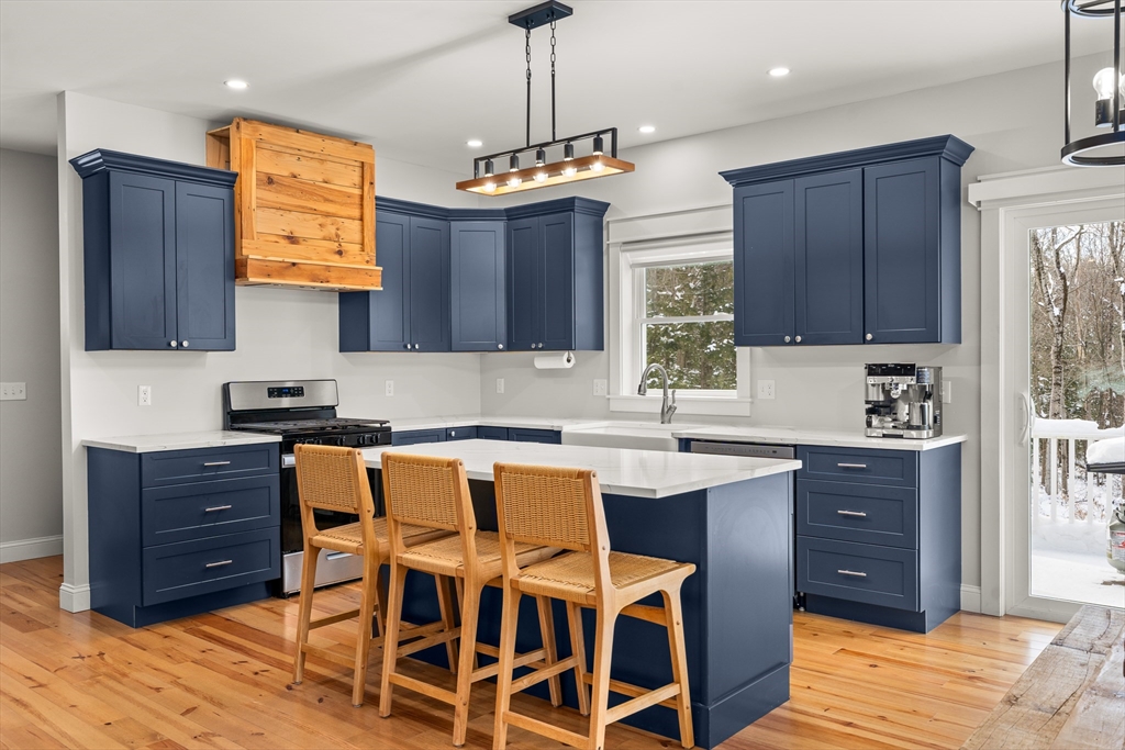 654 Skyline Trail Chester, MA 01011 - Photo 5 of 32 a kitchen with granite countertop wooden cabinets and center island