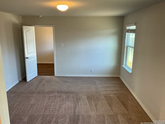 a view of a big room with windows and closet