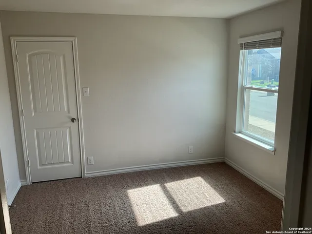 an empty room with closet area