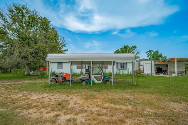 a view of a house with backyard sitting area and garden