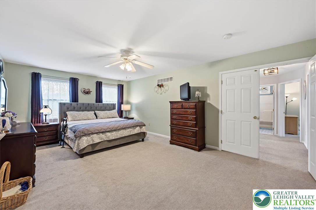 2011 Fieldview Drive Nazareth, PA 18064 - Photo 22 of 52 A generously sized primary bedroom provides comfortable living space with carpeted flooring and ample natural illumination.