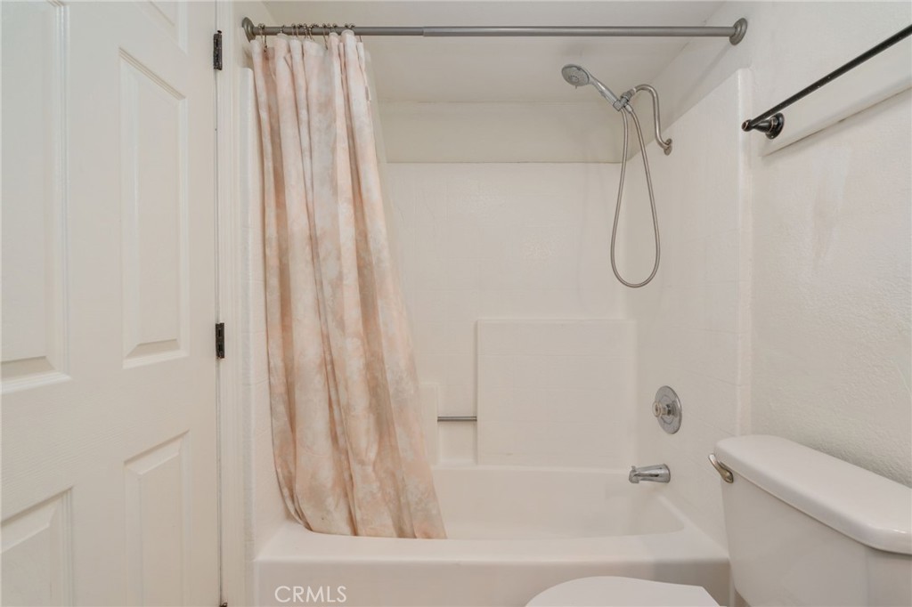 3535 Banbury Drive, Unit 119 Riverside, CA 92505 - Photo 16 of 23 a bathroom with a shower curtain and a shower curtain