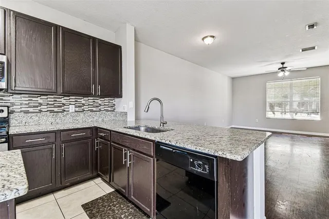 a kitchen with stainless steel appliances granite countertop a sink stove and cabinets