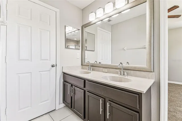 en empty room with closet and a chandelier fan