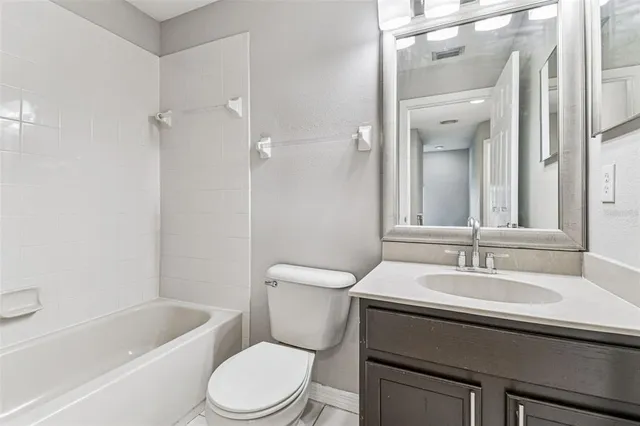 an empty room with fan and windows