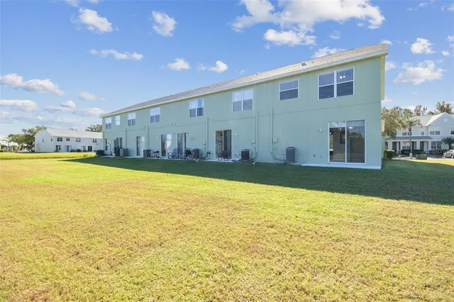 an aerial view of a swimming pool with seating space