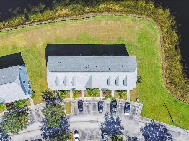 an aerial view of a house with outdoor space patio and trees all around