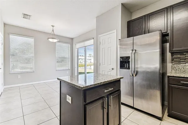 a kitchen with stainless steel appliances a sink and a refrigerator