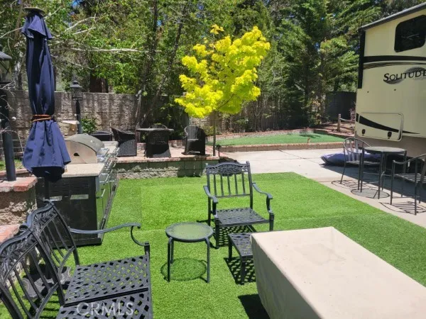 a view of yard with seating area and trees