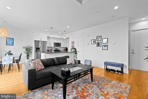 a view of a dining room with furniture and a potted plant
