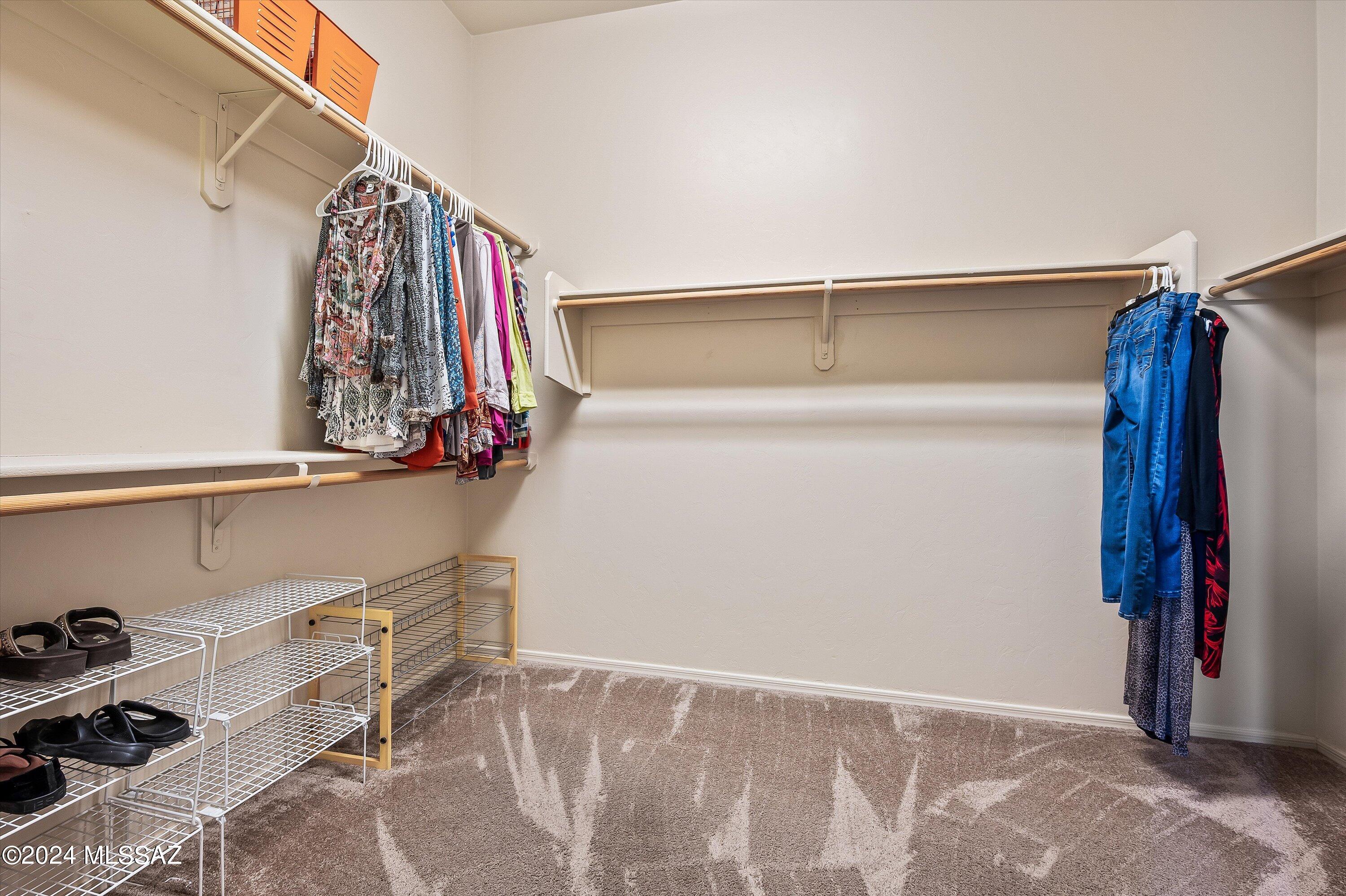 8579 North Shadow Wash Way Tucson, AZ 85743 - Photo 26 of 34 a view of walk in closet with clothes and shoes