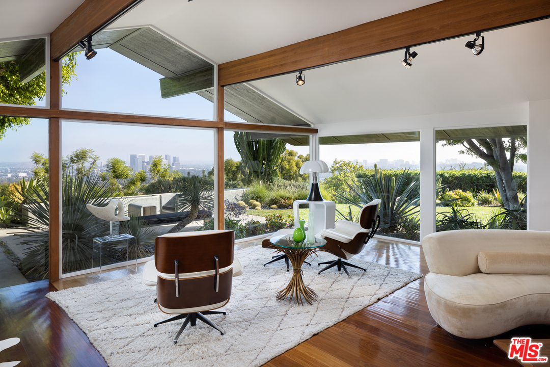 1375 Summitridge Place Beverly Hills, CA 90210 - Photo 2 of 21 a living room with patio furniture and a potted plant