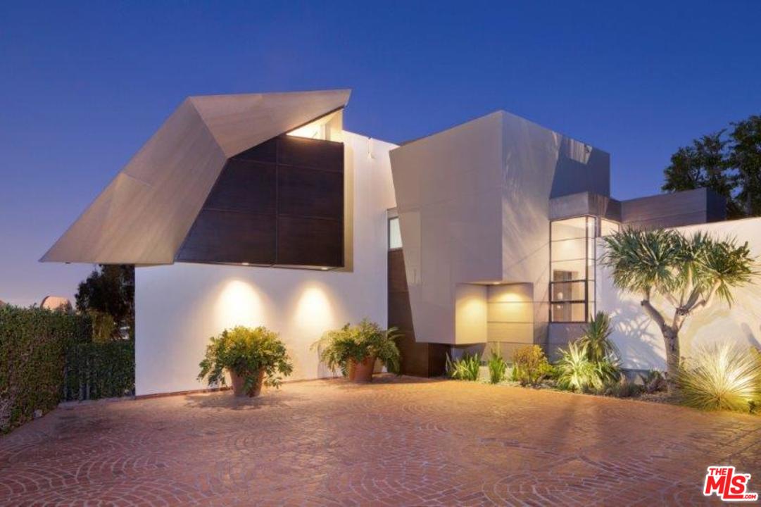 1375 Summitridge Place Beverly Hills, CA 90210 - Photo 16 of 21 a front view of a house with a yard and garage