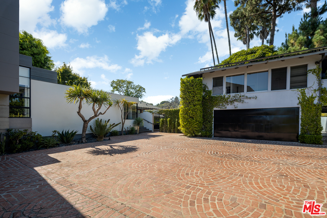 1375 Summitridge Place Beverly Hills, CA 90210 - Photo 20 of 21 a pathway of a house with a yard