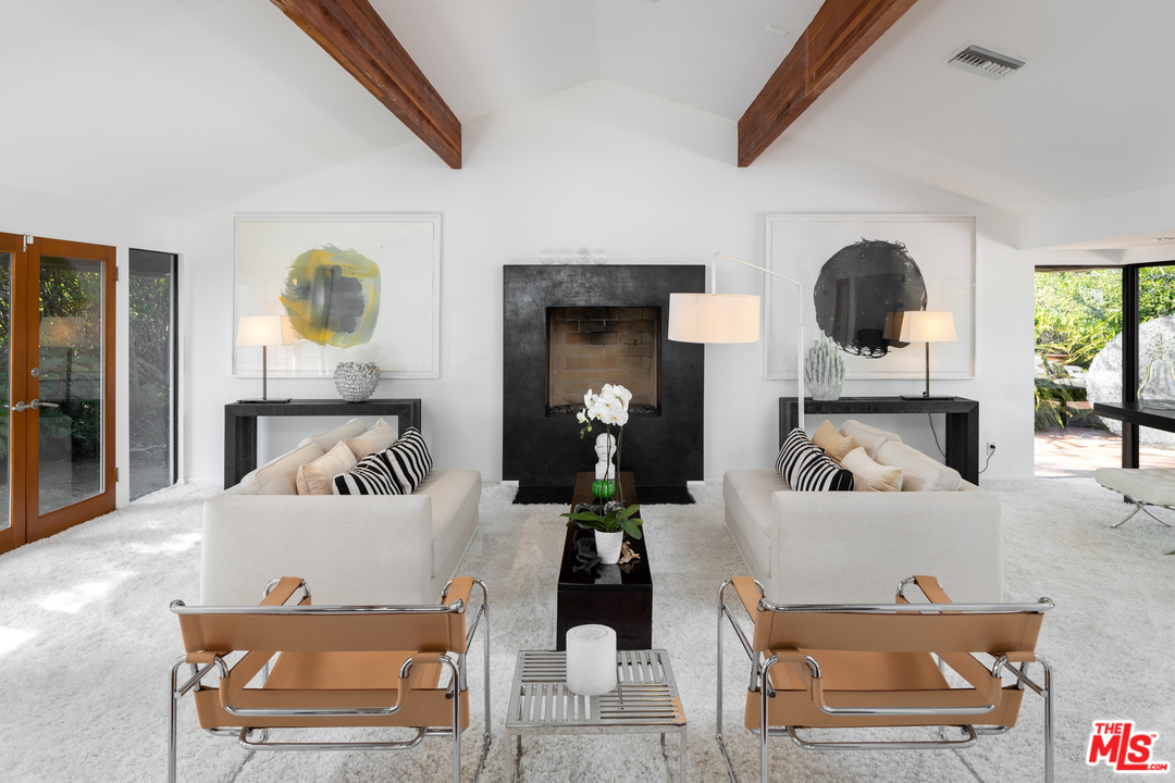 1375 Summitridge Place Beverly Hills, CA 90210 - Photo 5 of 21 a living room with furniture and a fireplace