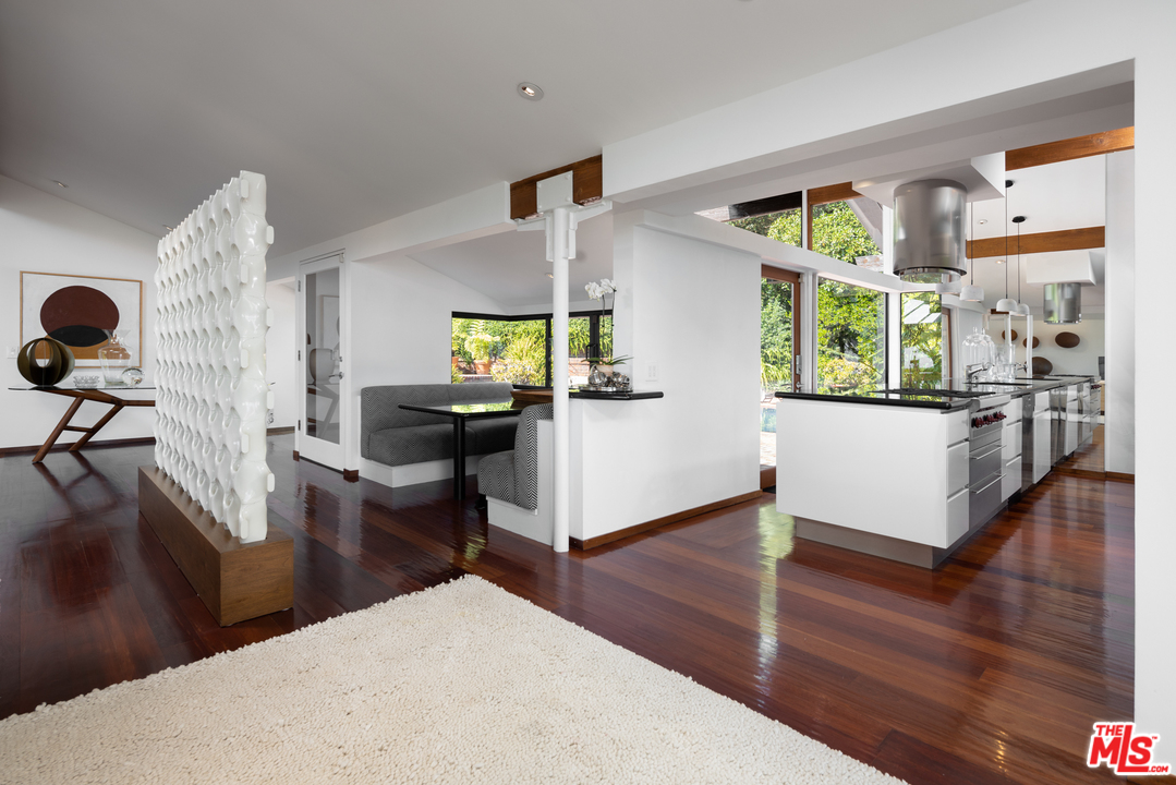 1375 Summitridge Place Beverly Hills, CA 90210 - Photo 7 of 21 a living room with furniture and a wooden floor
