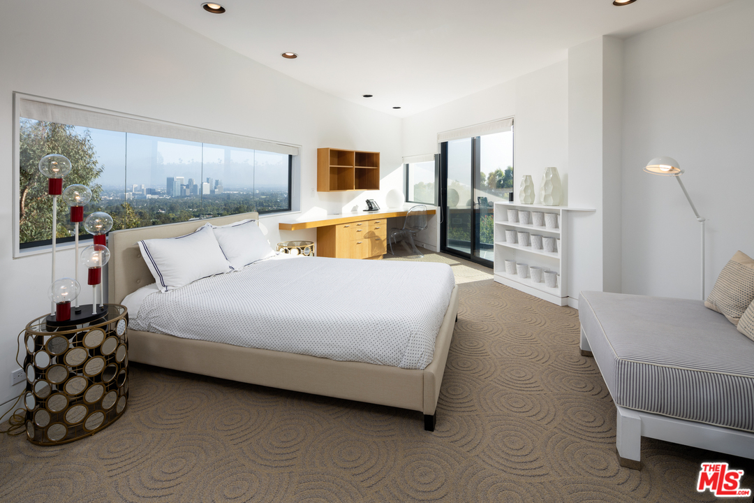 1375 Summitridge Place Beverly Hills, CA 90210 - Photo 10 of 21 a bed room with a bed and a couch