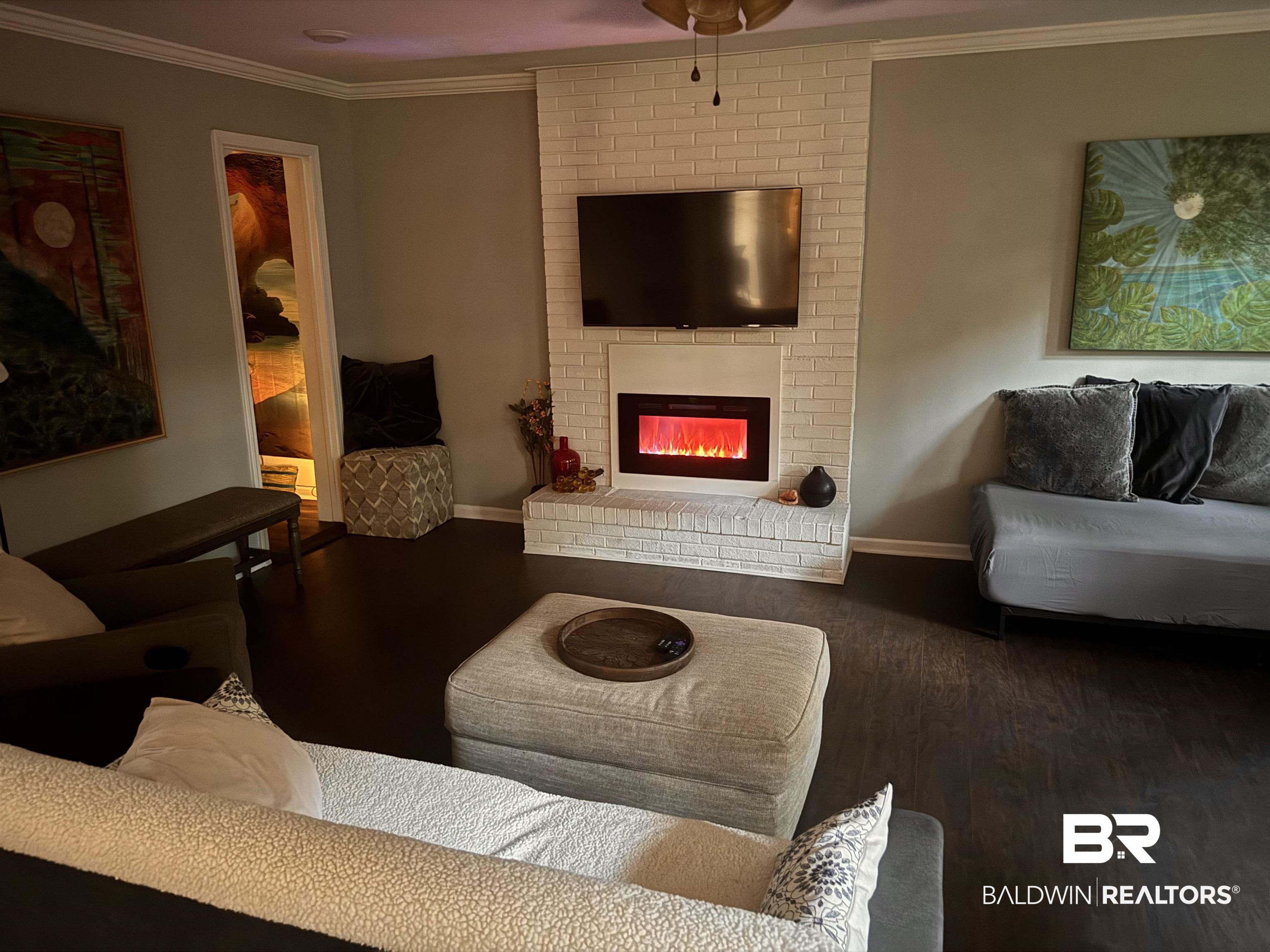 1302 Oak Street Daphne, AL 36526 - Photo 5 of 34 Living room featuring ornamental molding, a fireplace, and wood finished floors