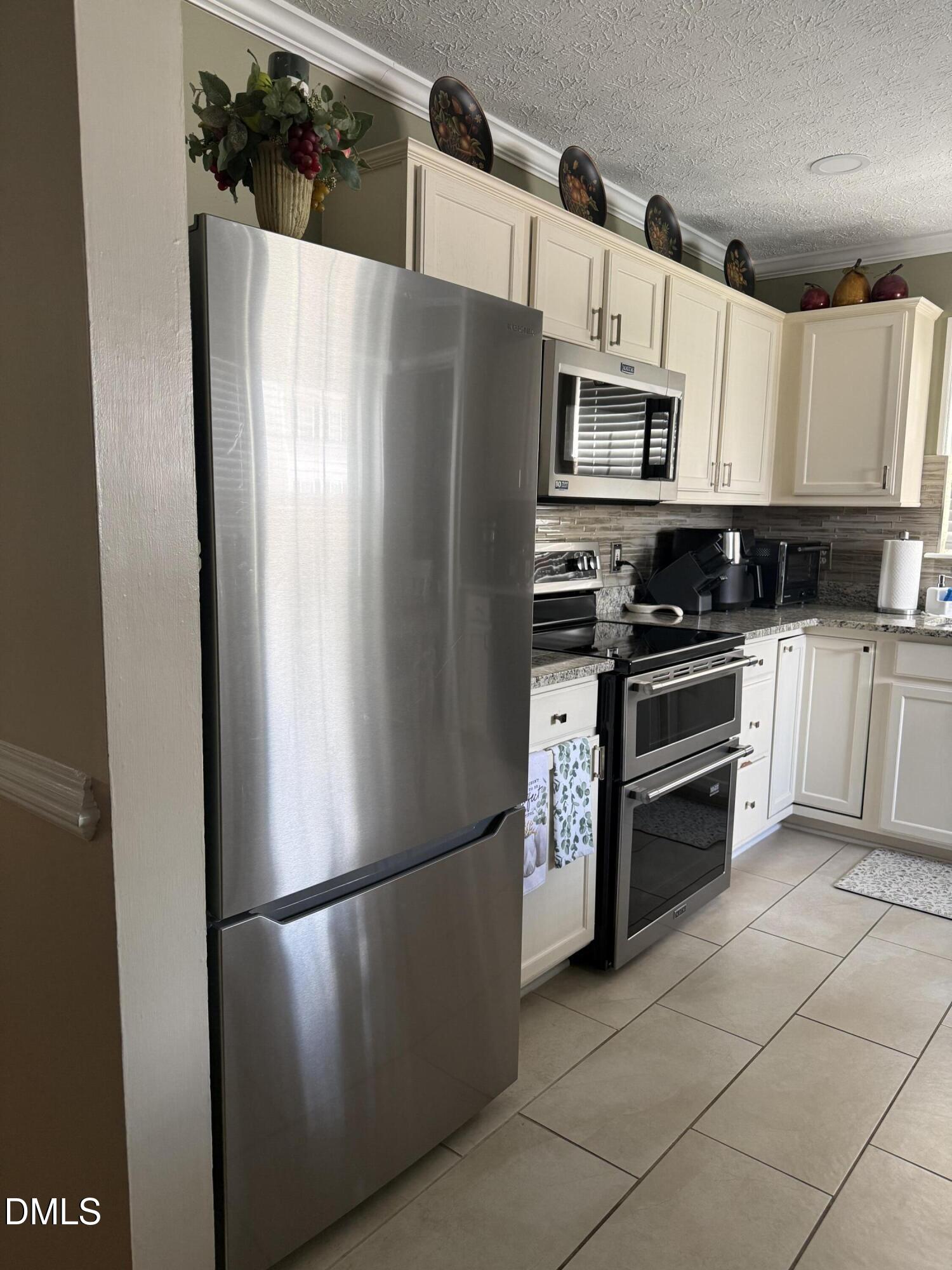 3616 Ranbir Drive Durham, NC 27713 - Photo 17 of 42 a white refrigerator freezer sitting in a kitchen