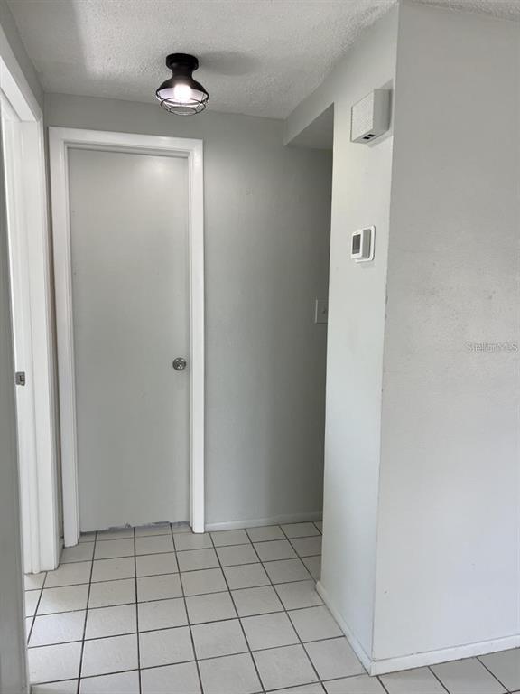 9011 St Clair Lane Port Richey, FL 34668 - Photo 11 of 20 a view of an empty room with window and chandelier fan