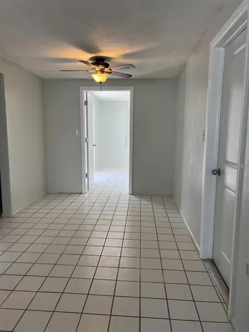 a view of a livingroom with an empty space and a window