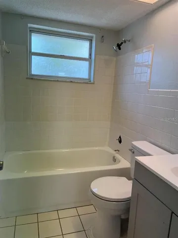 a bathroom with a toilet a sink and bathtub