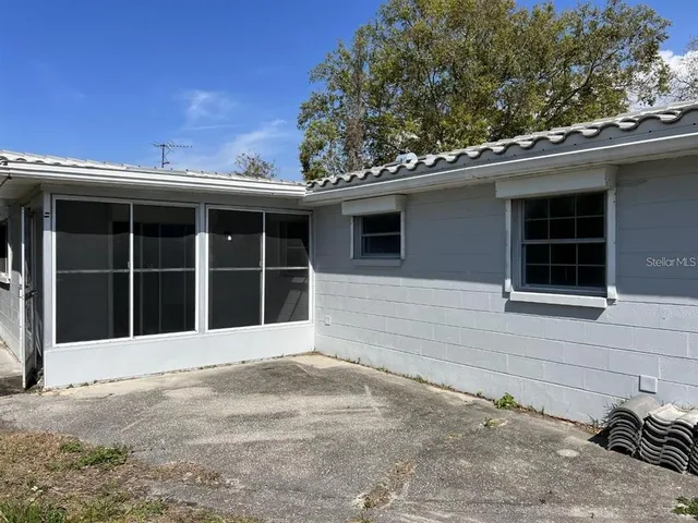 a front view of a house with a large window and a yard