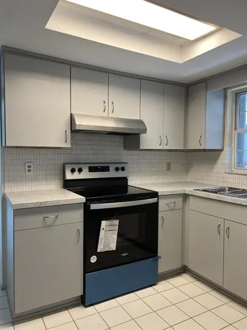 a kitchen with a stove and a sink
